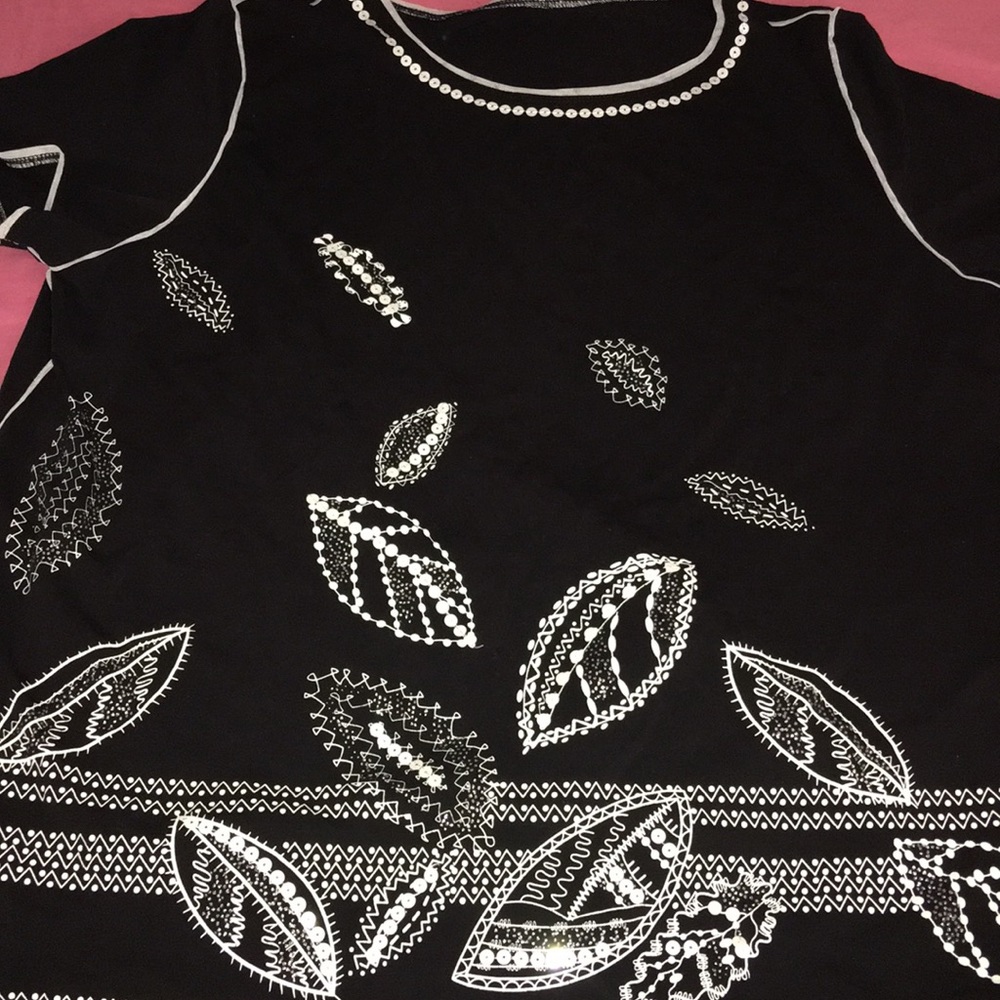 A black shirt with flower pedal design.